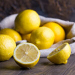 Group of fresh ripe lemon in sackcloth on an old vintage wooden table